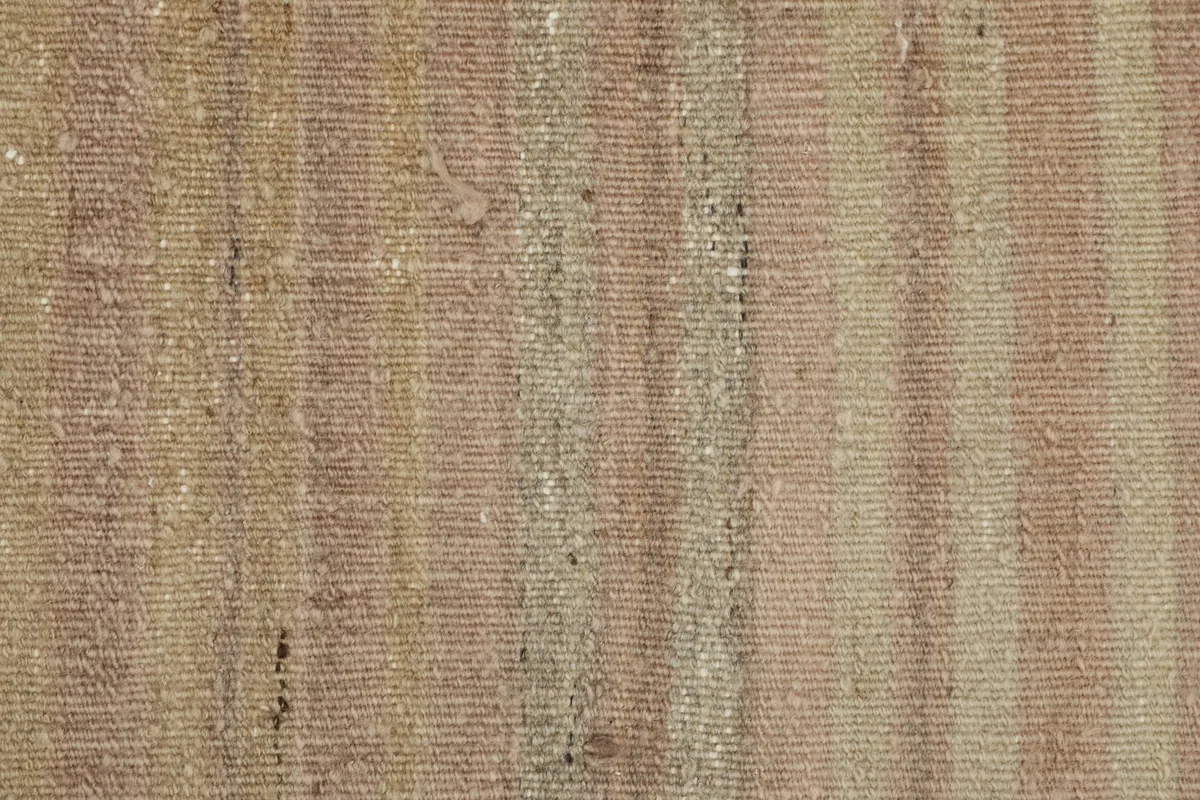 Detailed view of the low wool pile, showing individual knots and the subtle color shifts in the stripes.