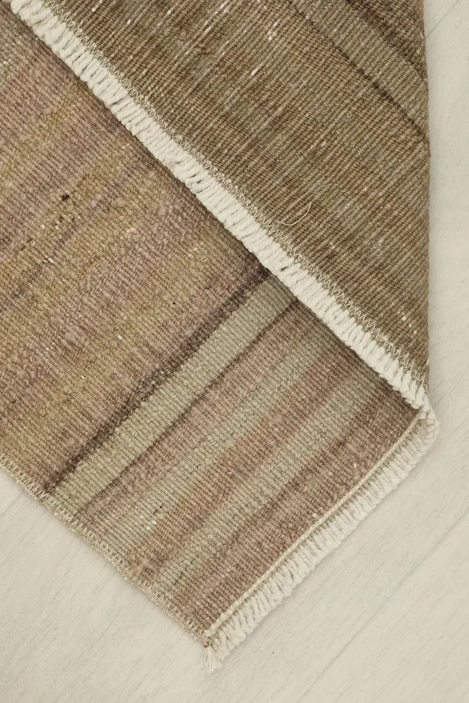 The rug folded to show its flexibility and the cotton foundation on the back.