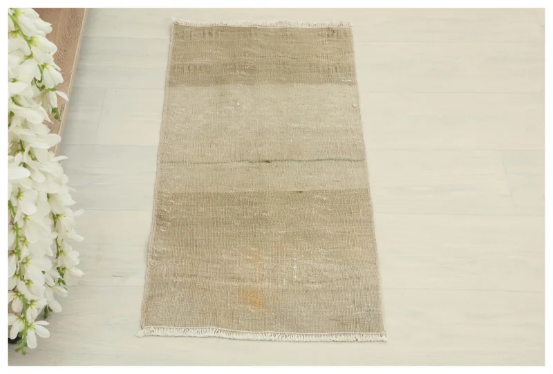 Full top view of the beige and tan striped vintage Anatolian rug on a white background.