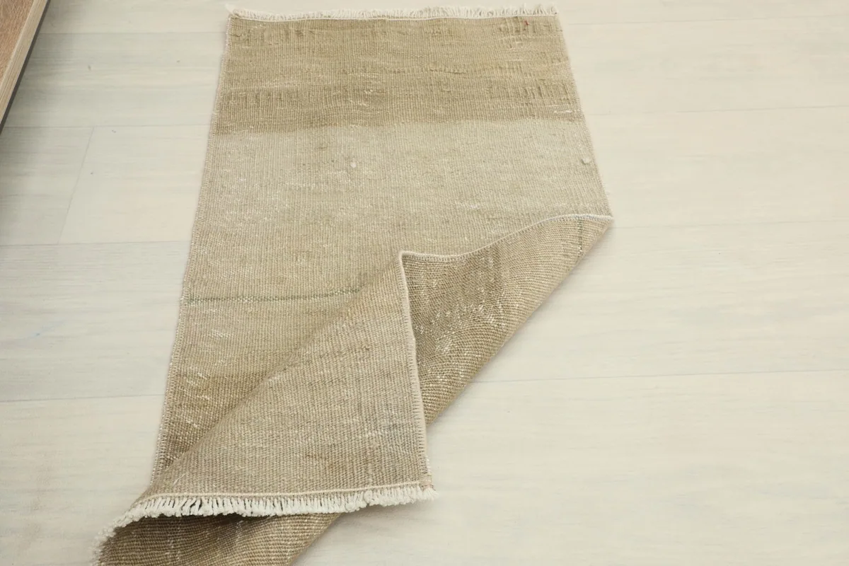 The rug partially folded, illustrating its flexibility and the subtle changes in color across its surface.