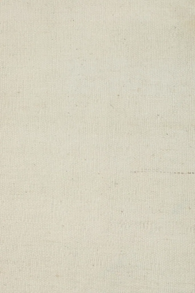 Extremely close view of the low wool pile, highlighting the texture and weave of the vintage rug