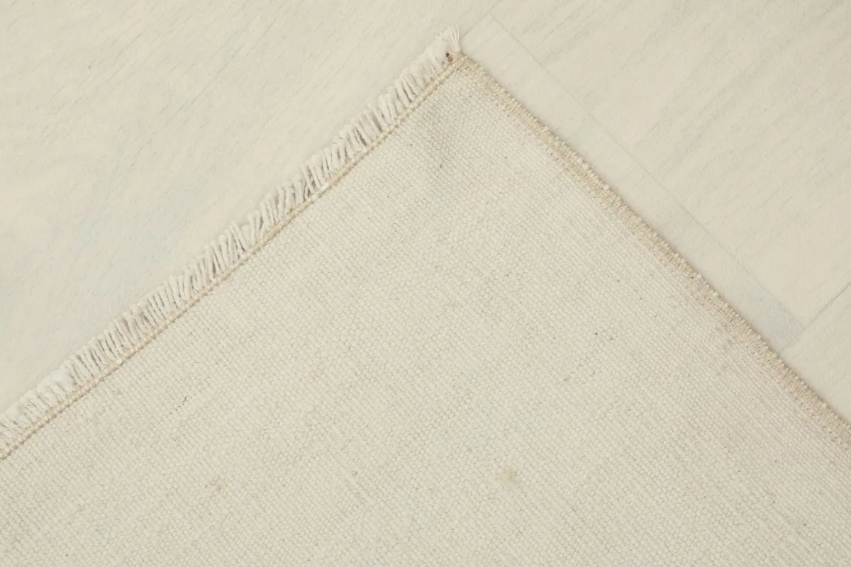 Underside view of the rug, revealing the cotton foundation and hand-knotted construction