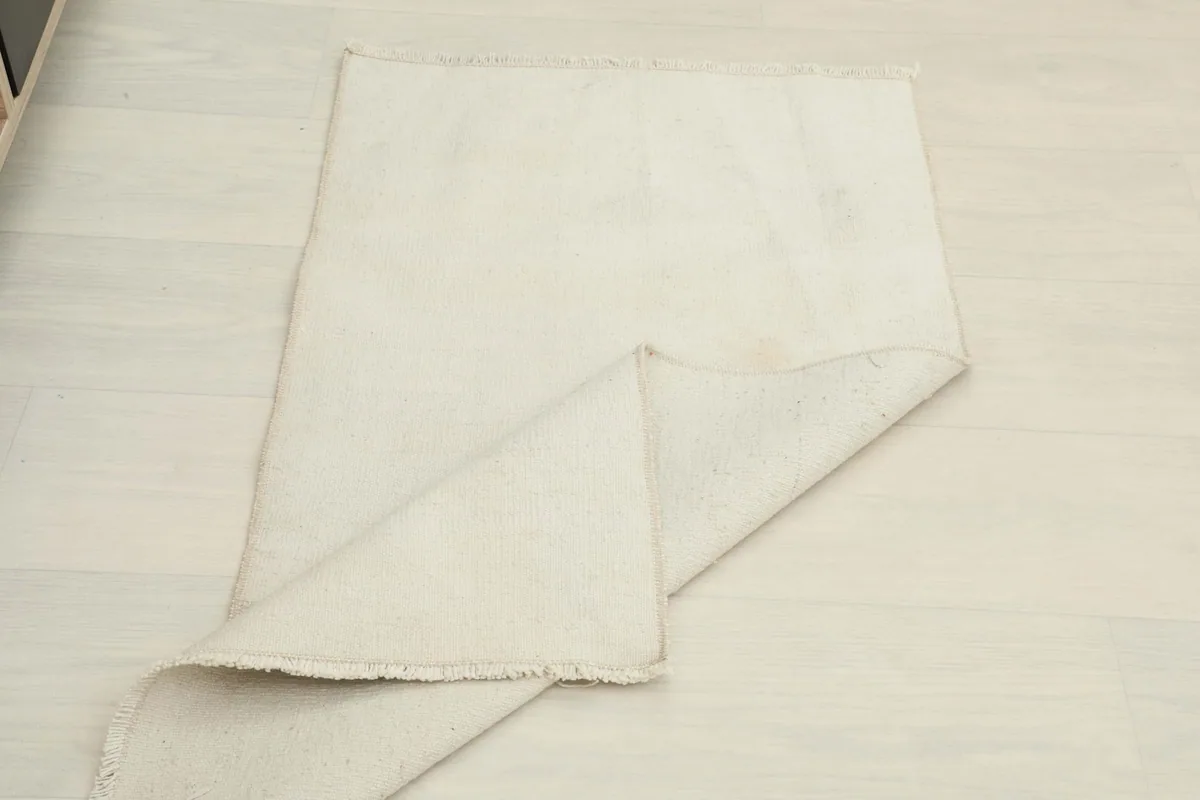 The rug partially folded, illustrating its flexibility and thickness