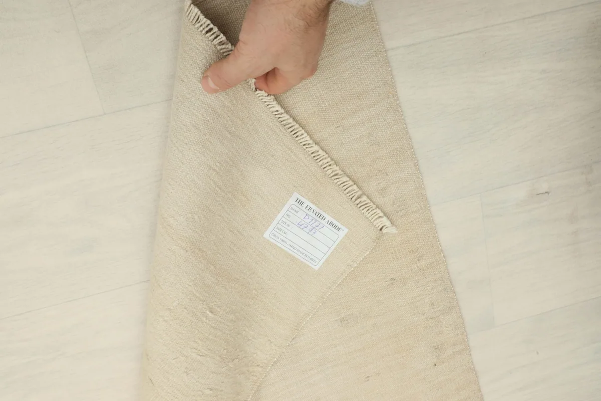 View of the rug's reverse side, revealing the cotton foundation and fine hand-knotting.