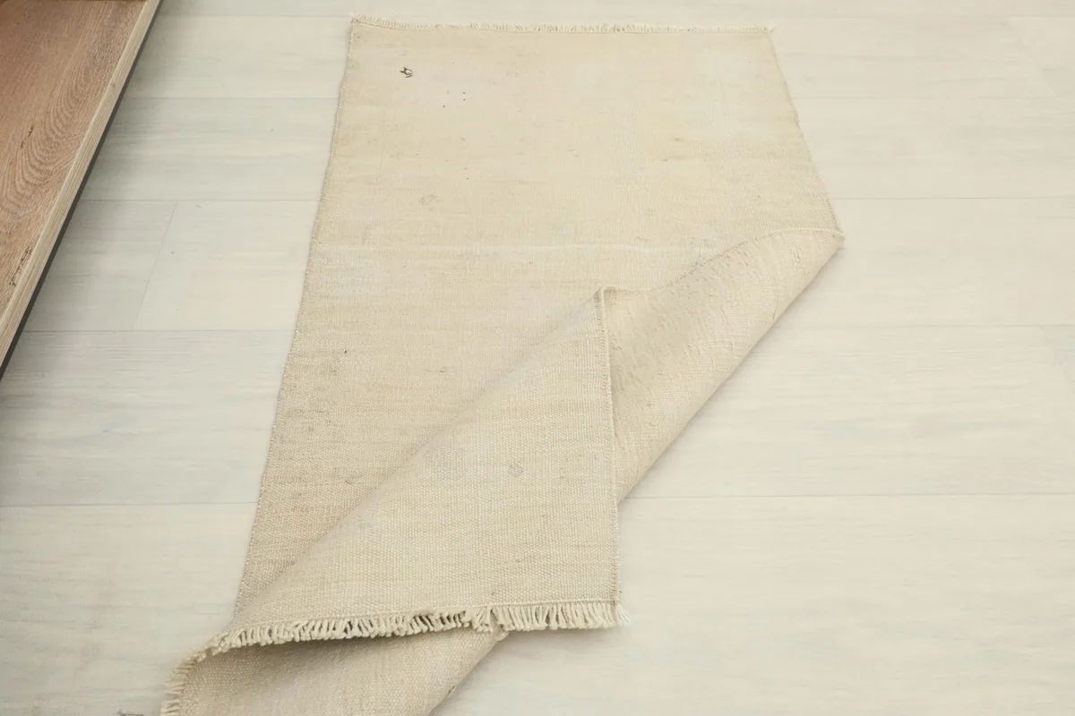 The rug partially folded, illustrating its compact size and easy handling.