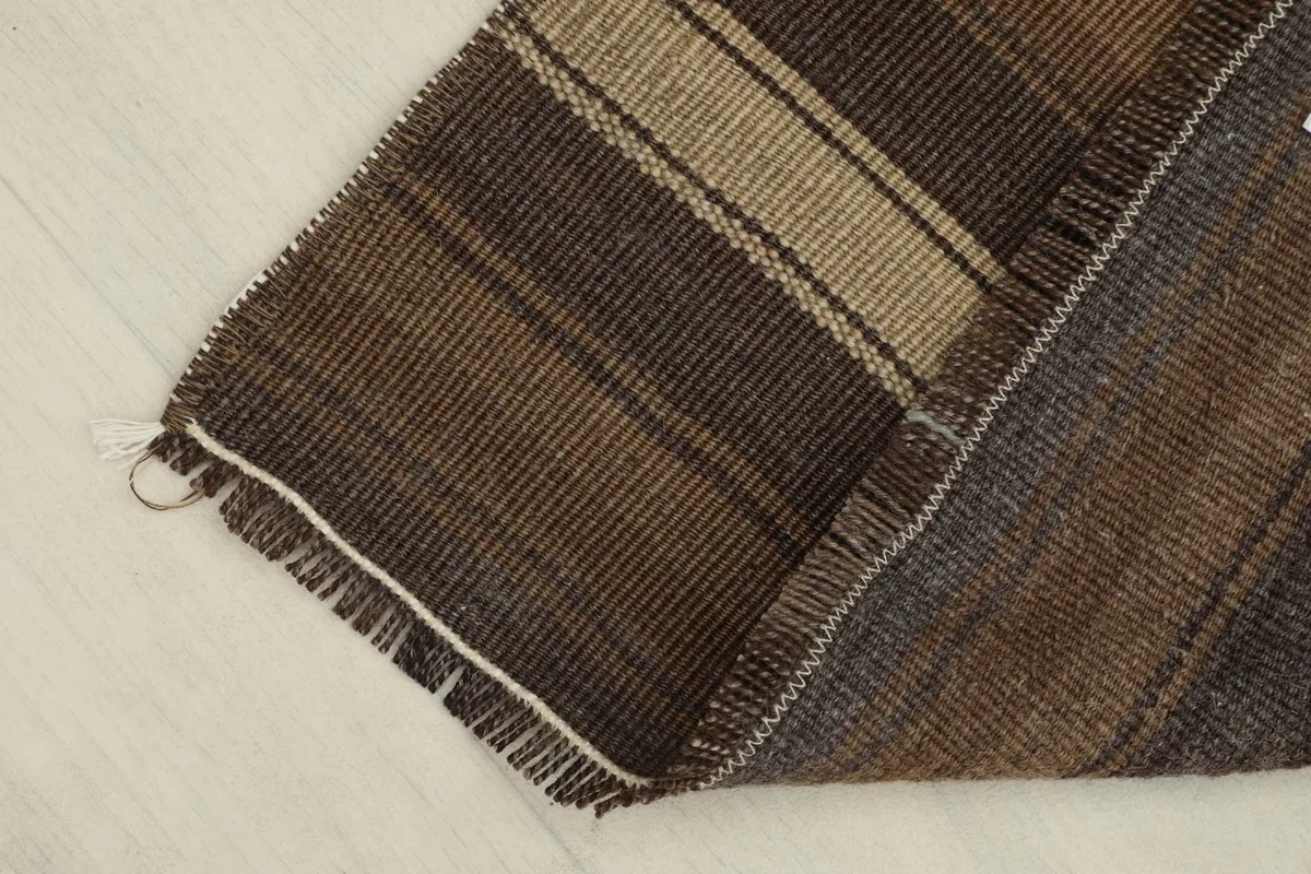 View of the rug's reverse side, revealing the hand-knotted cotton foundation and wool pile