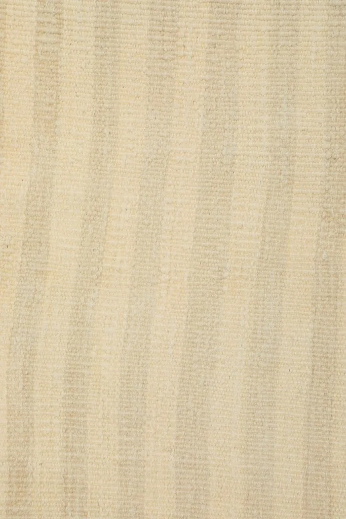 Vertical close-up showing the uniform striped pattern and the low pile texture of the vintage rug.