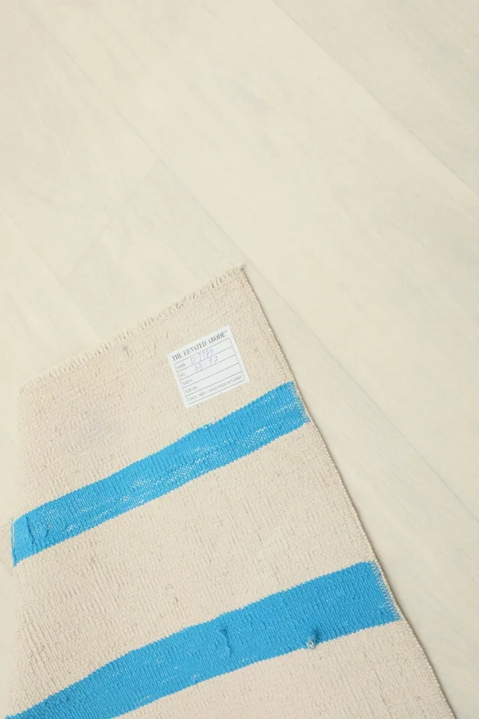 Close-up of the rug's label on the reverse side, showing origin and material information.