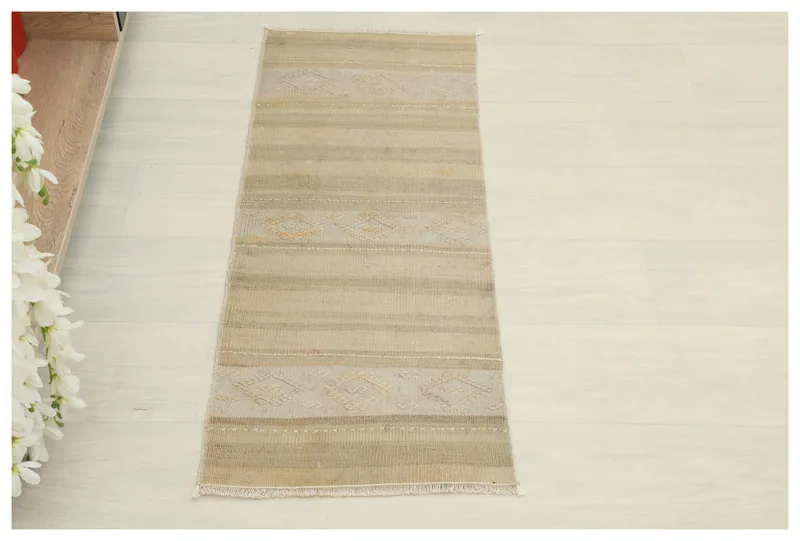 Full top view of the 1x3 beige striped geometric runner rug on a light floor.