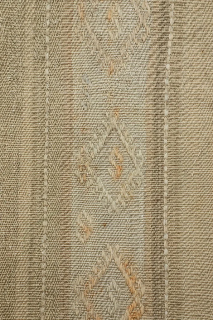Detailed view of the diamond-shaped tribal motifs and woven texture.