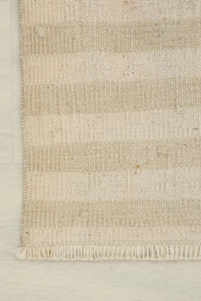 Overhead corner view showing the striped pattern and finished edge of the rug.