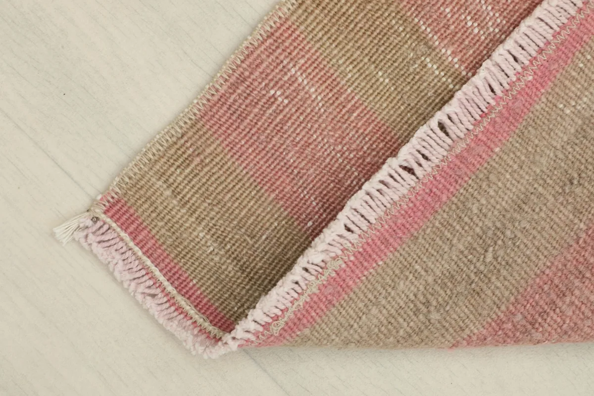 The rug folded to reveal the reverse side, showing its cotton foundation and craftsmanship.