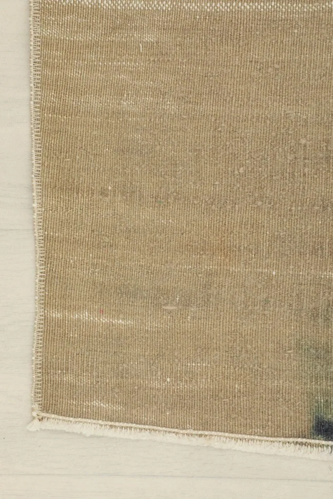 Edge detail of the rug, showing the finishing and fringe along one side