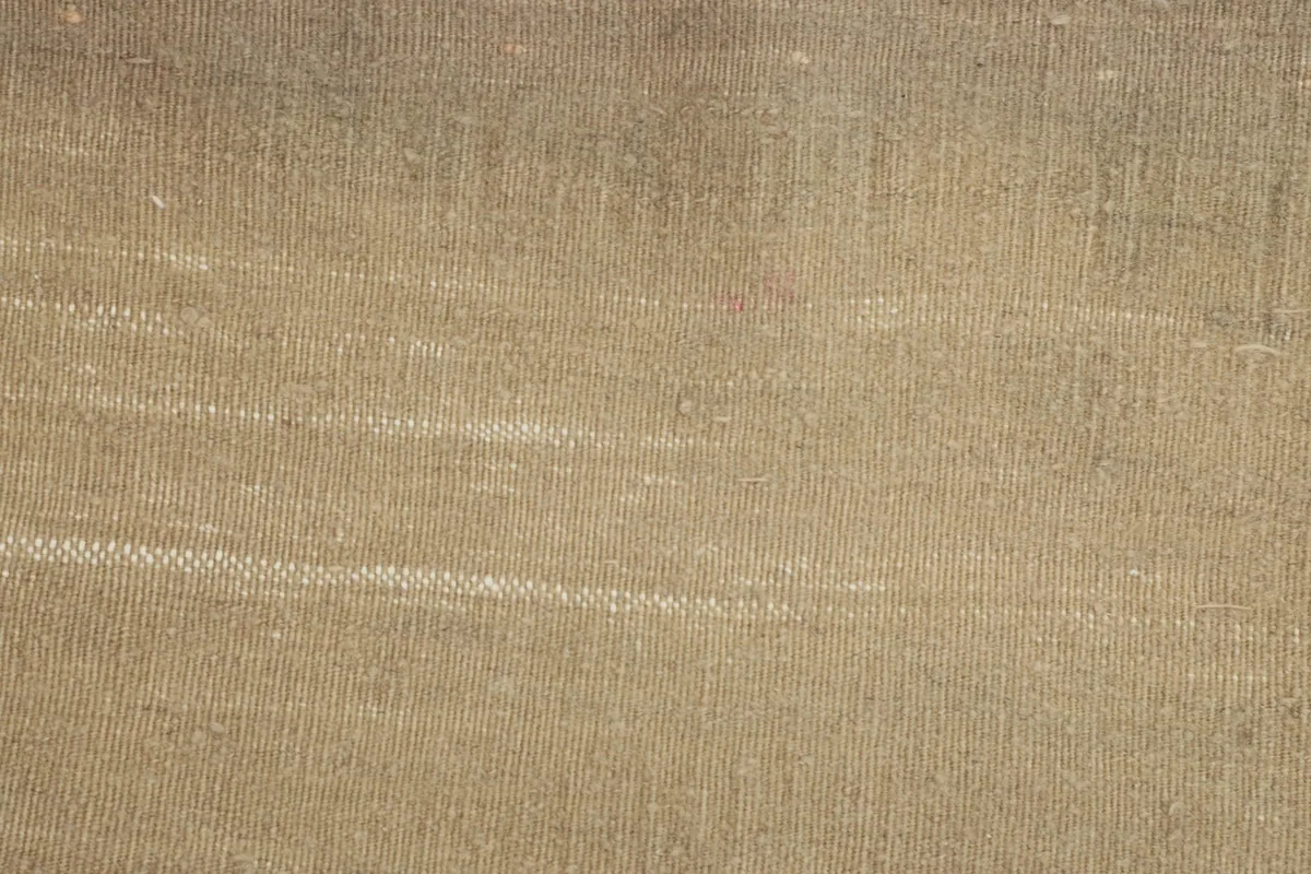 Close-up of the low wool pile, highlighting the hand-knotted construction and natural wear