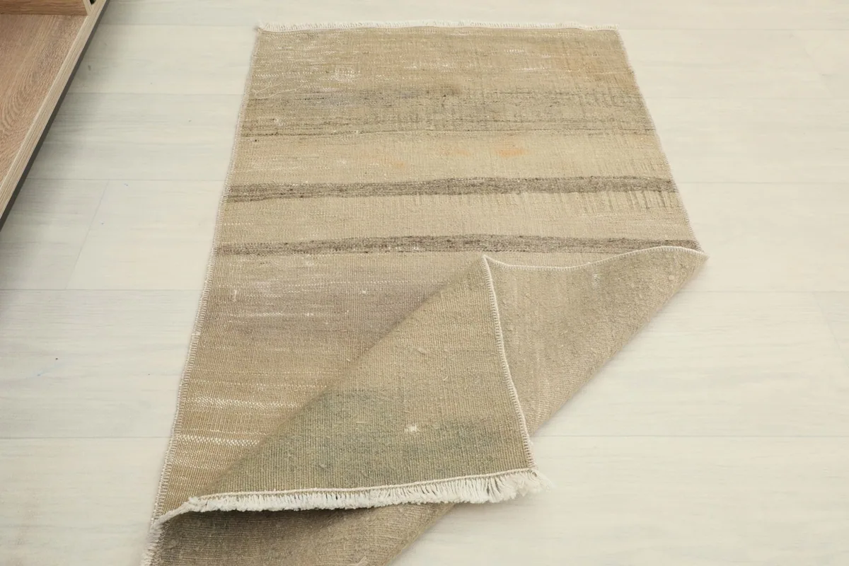 Overhead view of the rug with a corner folded, displaying both front and back textures