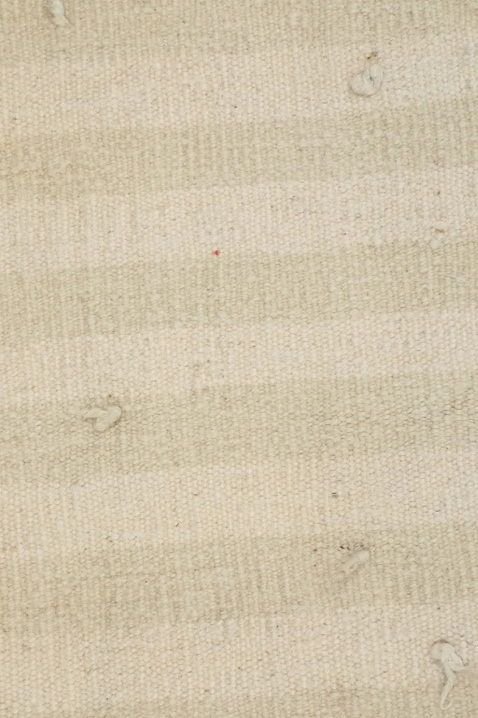 Detailed view of the low wool pile and the hand-knotted texture of the rug.