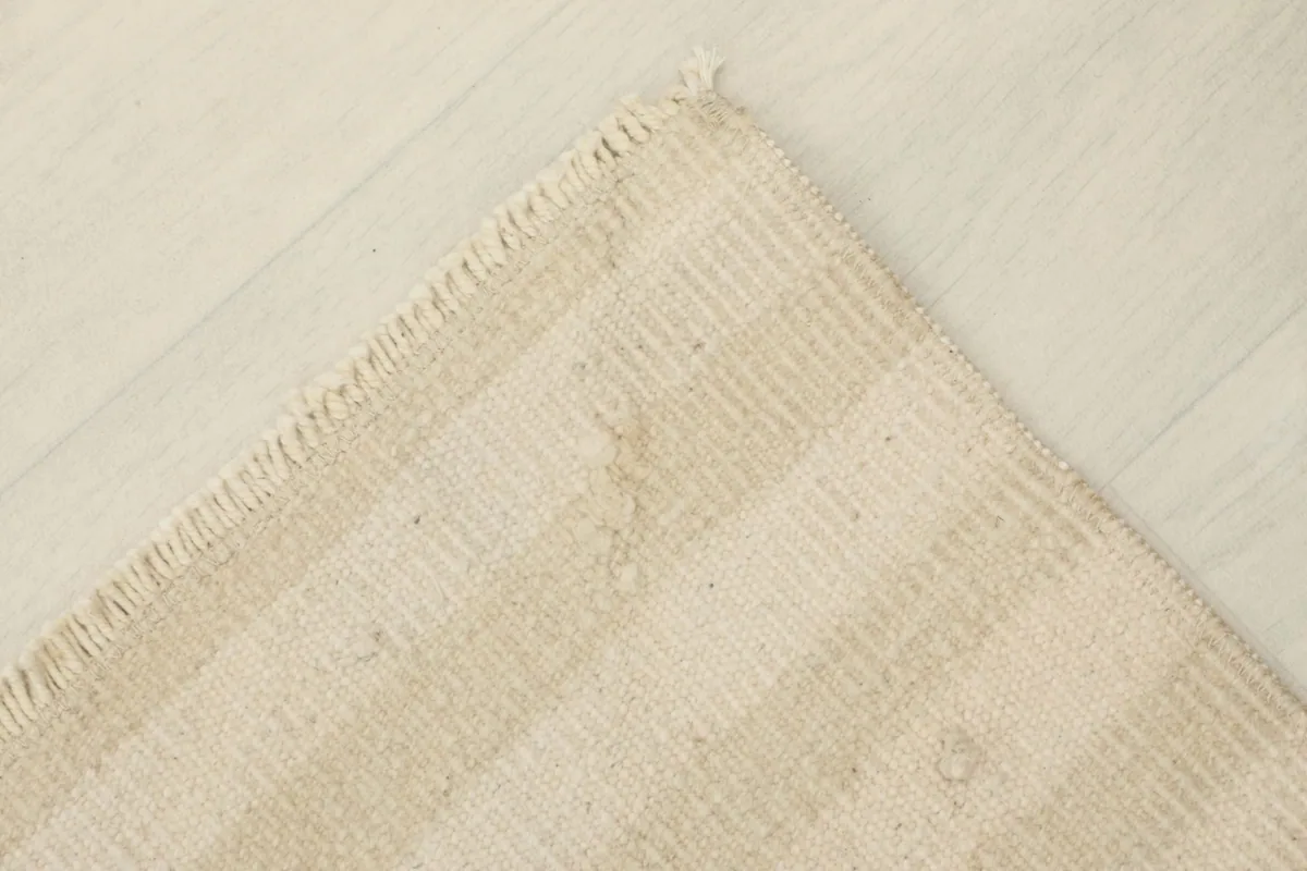 View of the back of the rug, revealing the cotton foundation and hand-knotted construction.