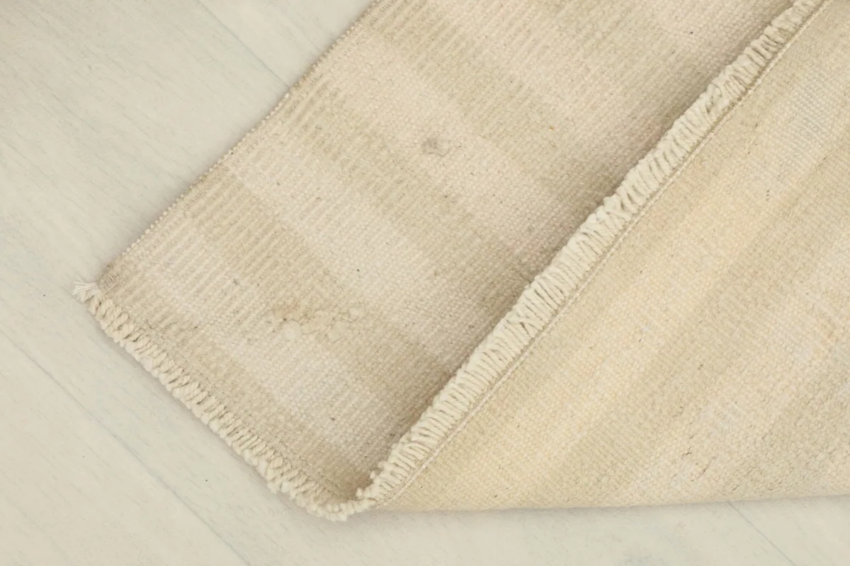 Rug partially folded, showing the flexibility and thickness of the material.