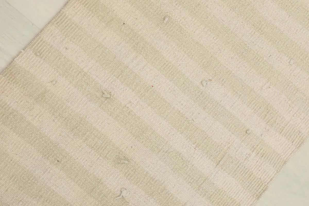 Overhead view of the rug, highlighting the subtle stripe pattern and texture.