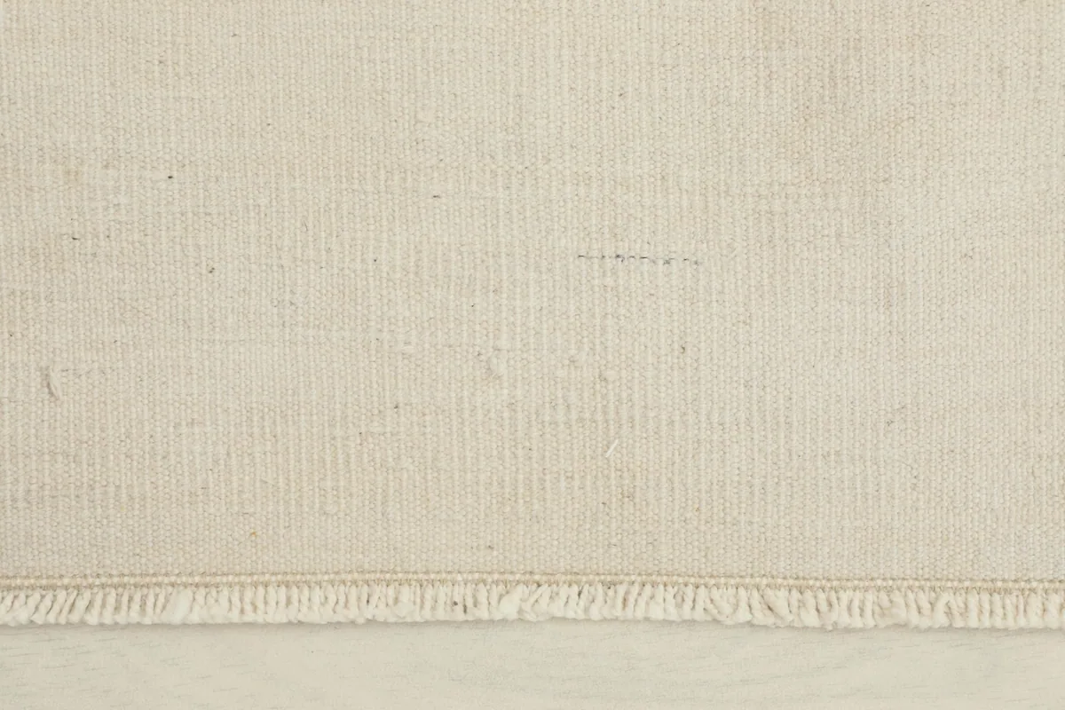 Close-up view of the rug's surface, showing the low wool pile and hand-knotted texture