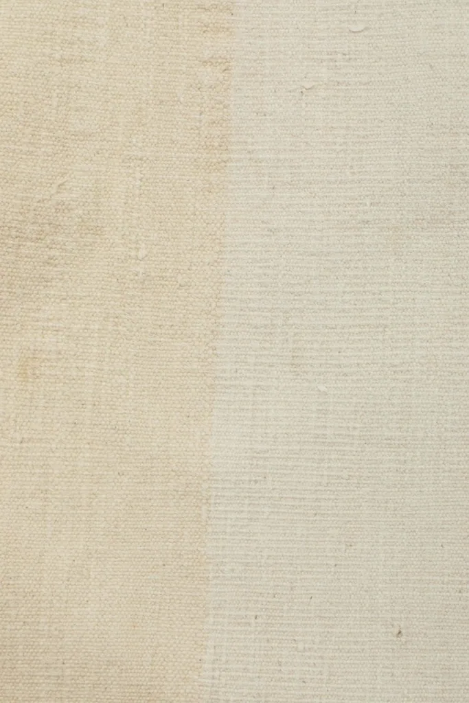 Close-up showing the distinct color banding and texture variation within the beige wool pile