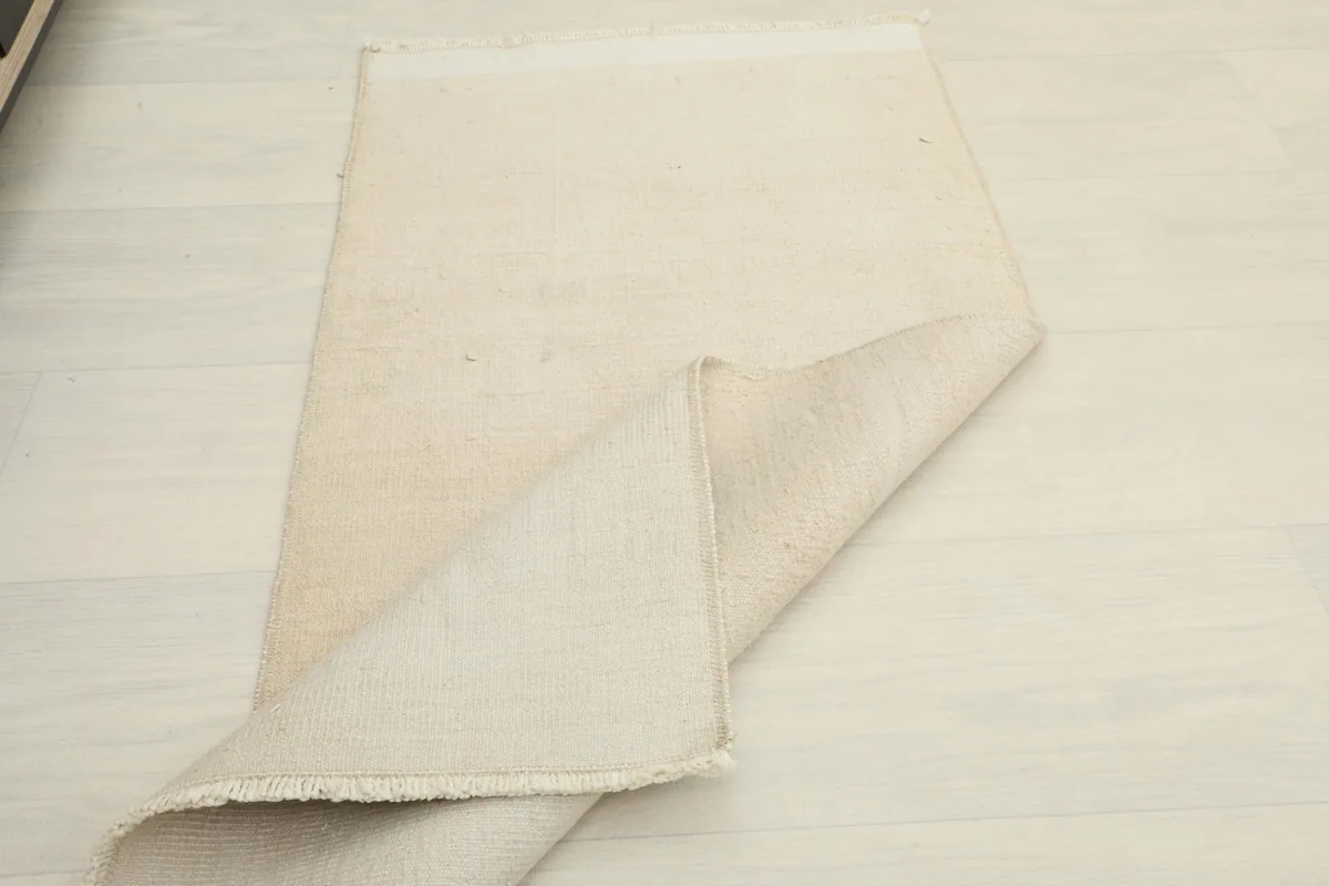 Another perspective of the rug folded, emphasizing its construction and material