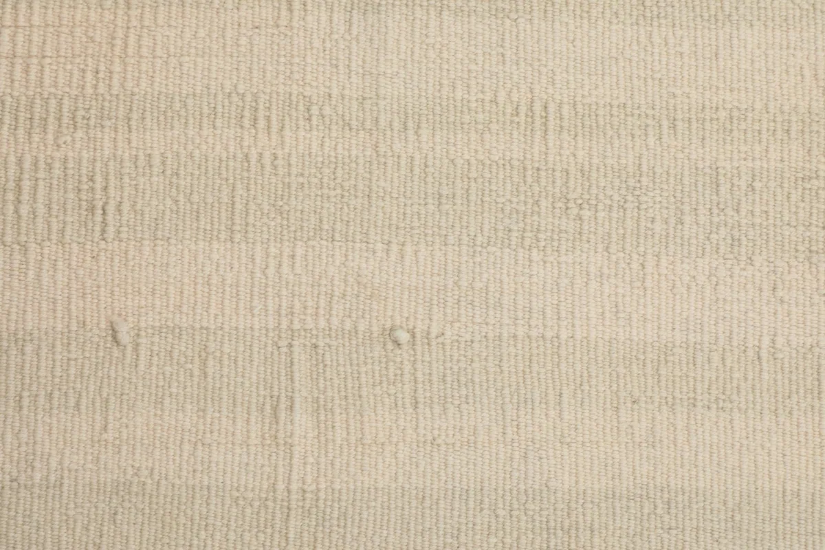 Detailed view of the low wool pile and the hand-knotted construction of the vintage doormat.