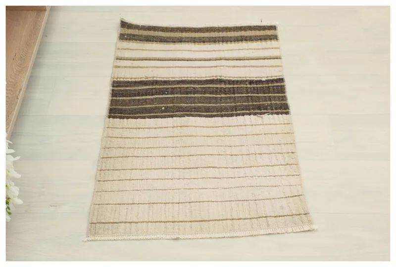 Full top view of the 1'7" x 2'11" hand-knotted vintage Anatolian doormat with beige and brown stripes.