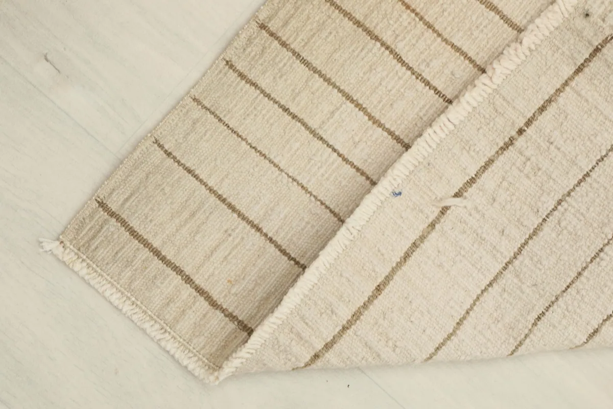 View of the back of the hand-knotted rug, revealing the cotton foundation and construction details.