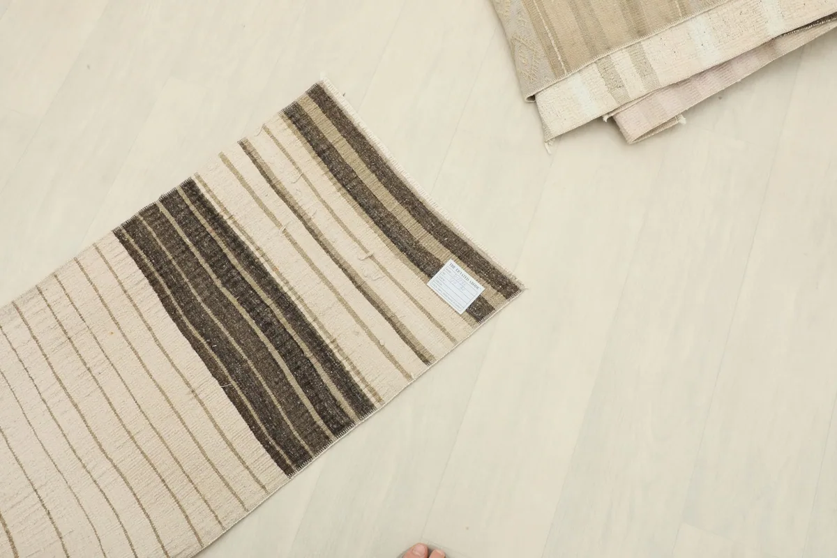 Overhead view of the doormat on the floor, showing the brand label and its overall appearance.