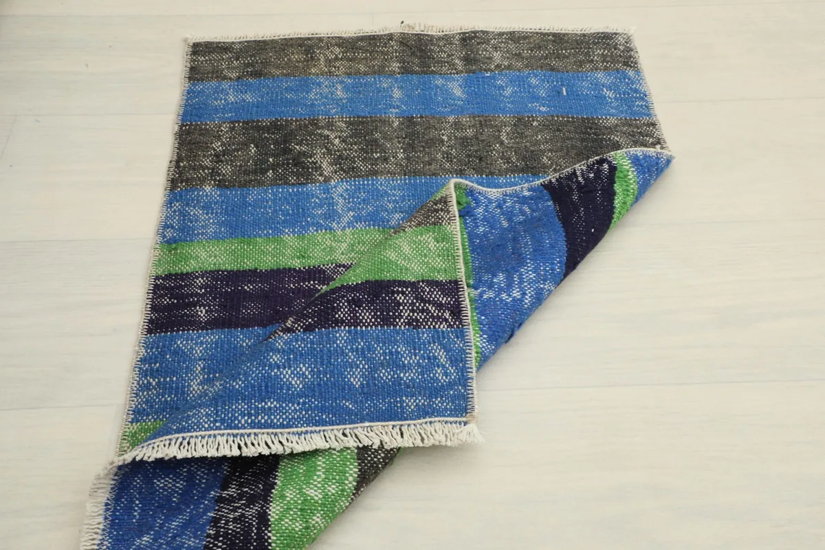 The rug folded over itself, displaying the full pattern and the thickness of the material.