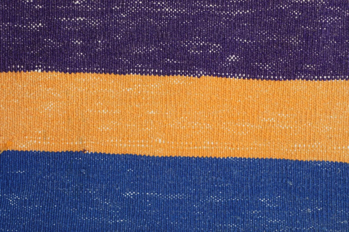 Tight detail shot of the rug's wool pile, revealing the texture and color blending.