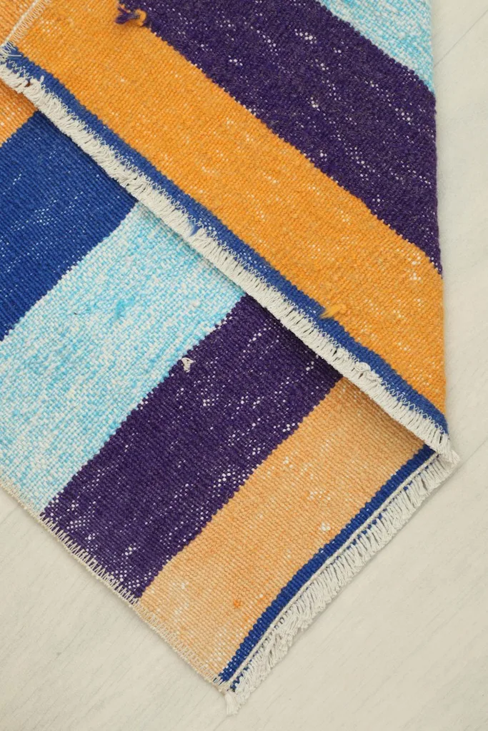 The rug folded to show its flexibility and thickness from a top-down perspective.