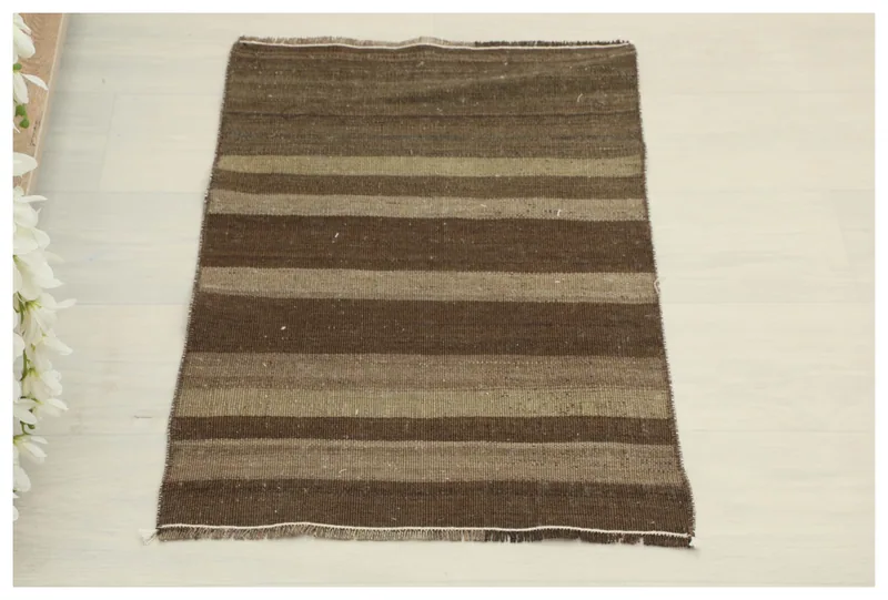 Full top view of the 1'6" x 2'4" brown and tan striped vintage Anatolian rug on a white background.