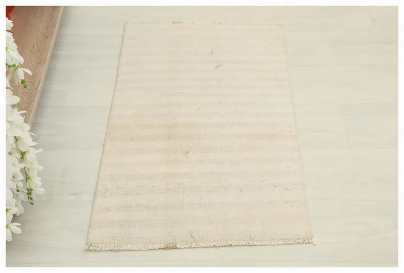 Full top view of the 1'8" x 2'9" ivory and beige vintage Anatolian rug on a white background.