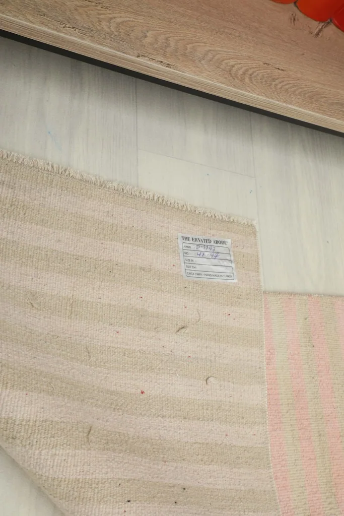 Close-up of the rug's label, providing information about its origin and materials.