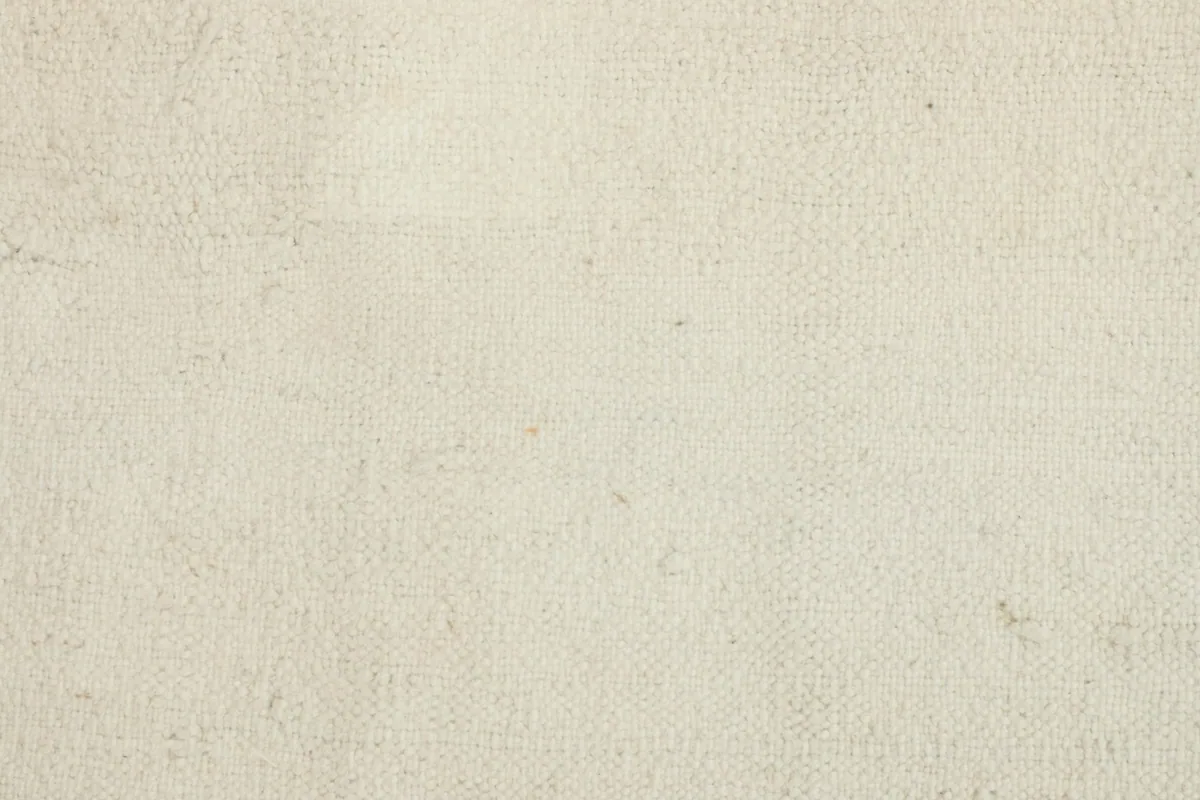 Detailed view of the low pile and tight weave of the vintage hand-knotted wool rug
