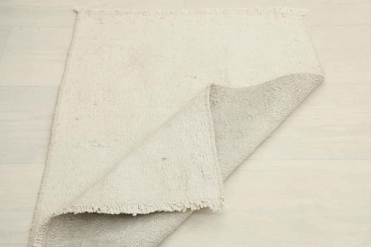 Another view of the rug partially folded, emphasizing its pliable nature