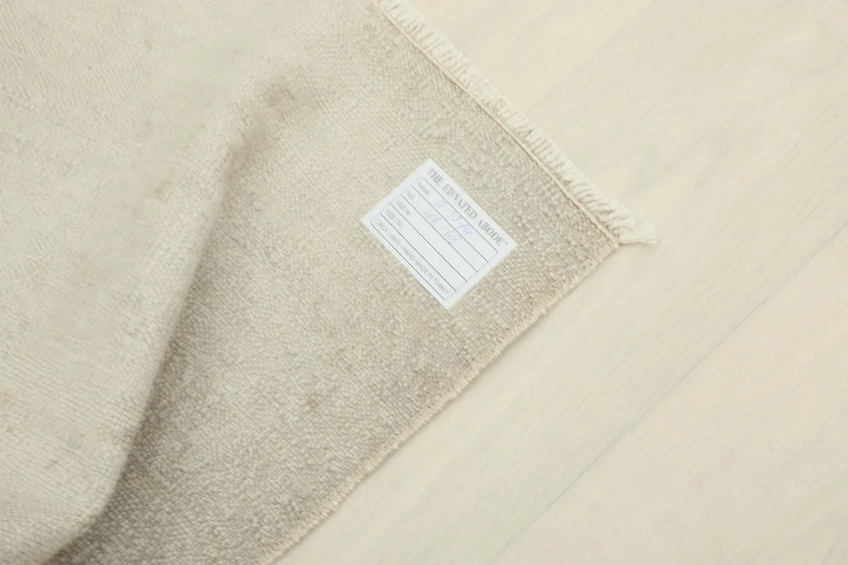 Close-up of the care label attached to the back of the vintage Anatolian wool rug
