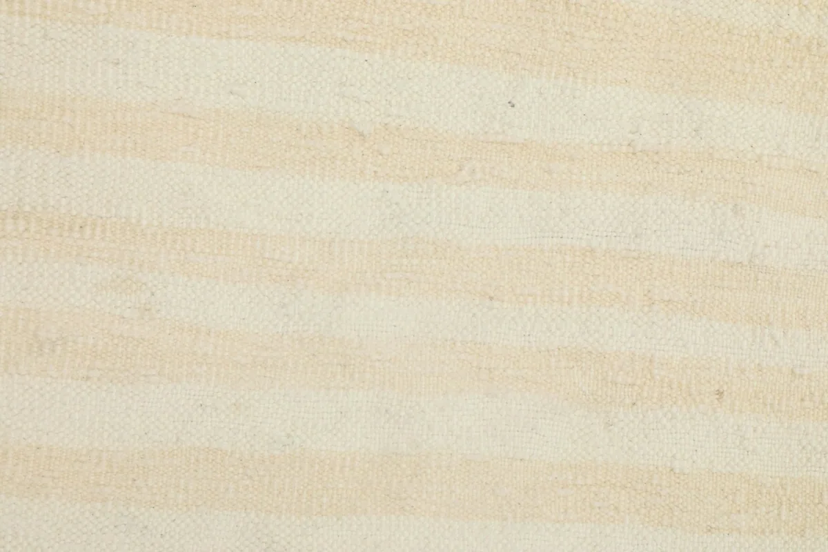 Detailed view of the varying cream and beige stripes and wool pile