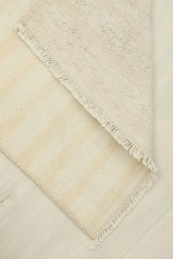 View of the reverse side of the rug, showing the cotton foundation
