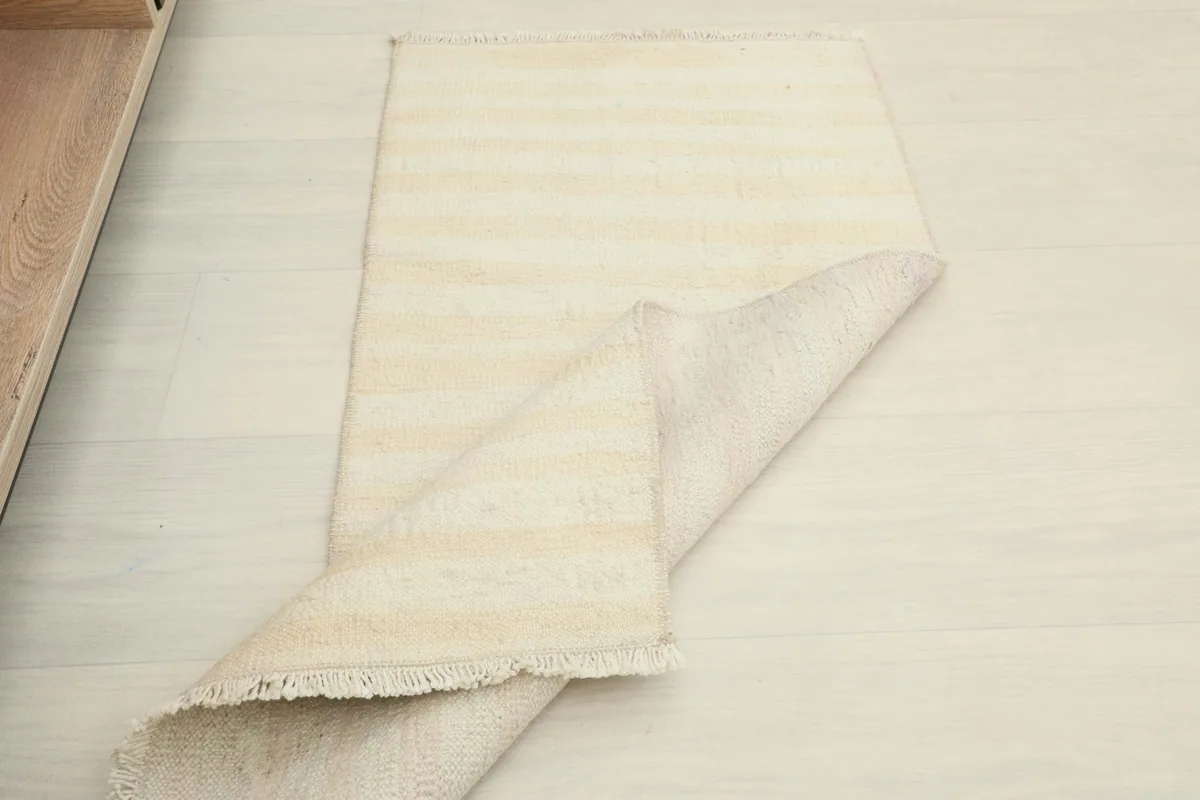 The rug partially folded, showing its flexibility and thickness