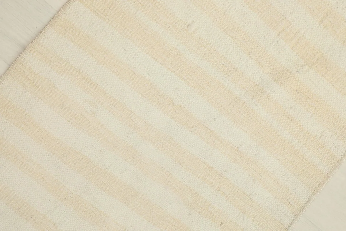 Overhead view showing the subtle striped pattern and texture of the rug