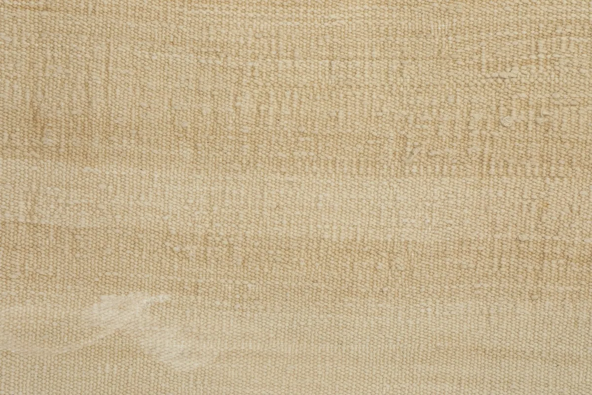 Extreme close-up of the hand-knotted wool pile, showing the tight weave and low height.