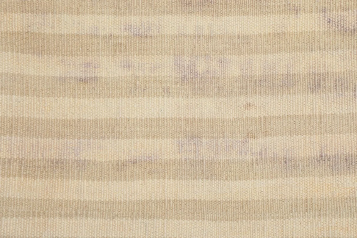 Detailed view of the low wool pile and the striped design, showing the weave variation.