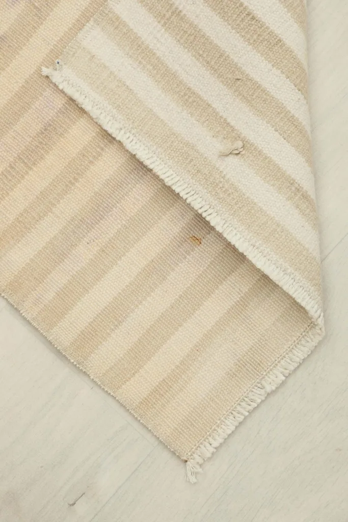 The rug folded to show the flexibility and thickness, revealing the reverse side.
