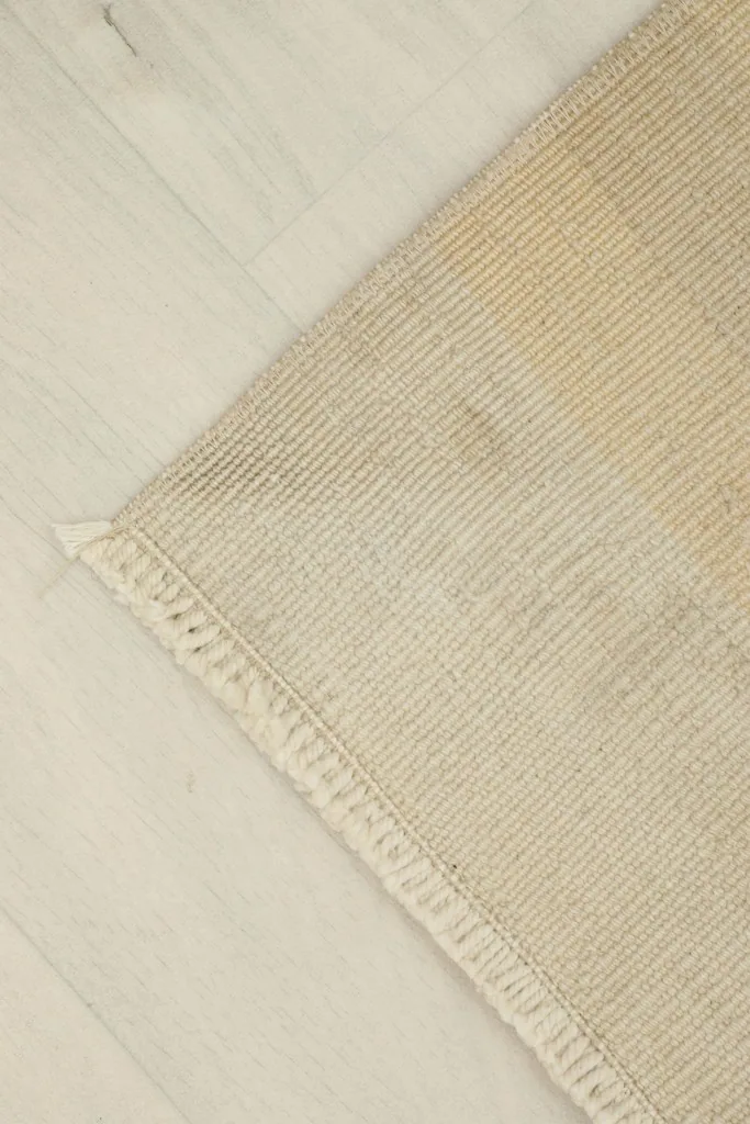 Corner view of the rug, showing the clean finish of the edges and fringe.