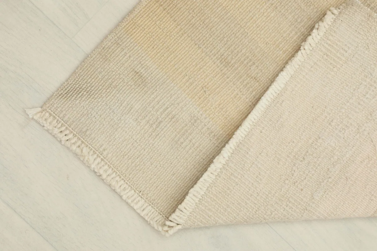 View showing the back of the hand-knotted rug and its cotton foundation.