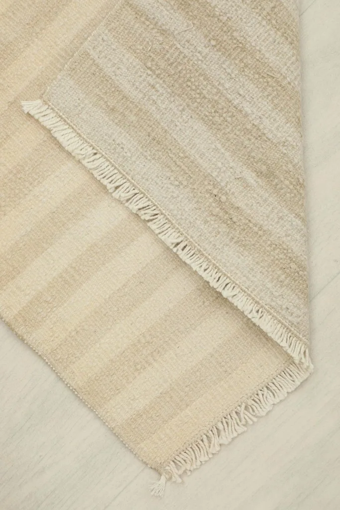 Partially folded rug showing both the front and back textures