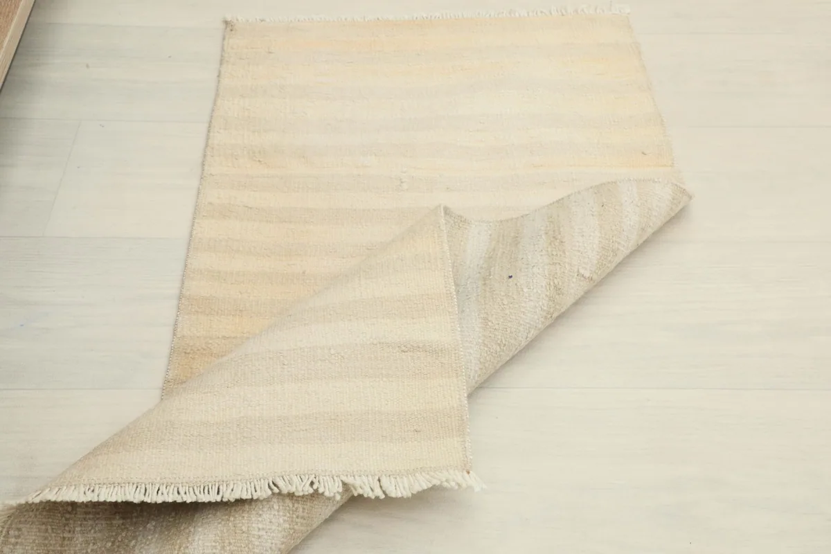 Rug partially folded over, highlighting its flexibility and construction